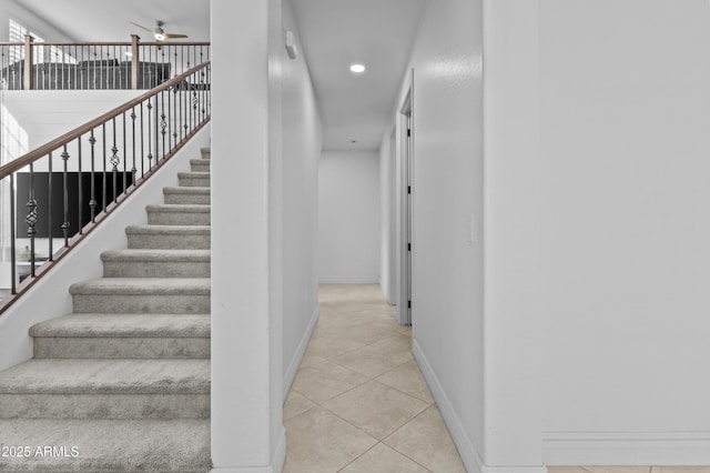 stairway featuring tile patterned flooring, recessed lighting, a ceiling fan, and baseboards