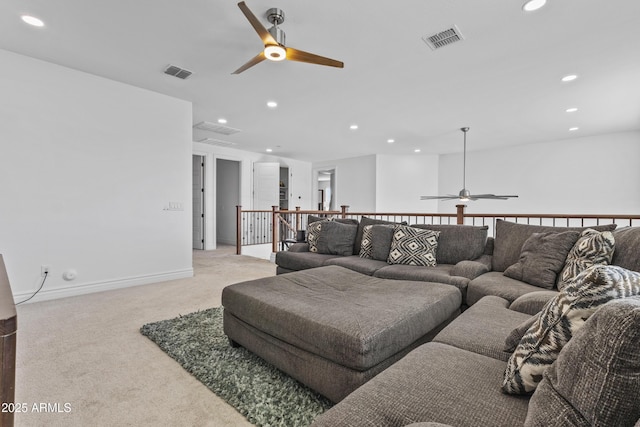 living room with recessed lighting, visible vents, and light carpet