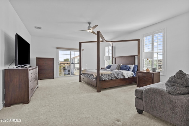 bedroom with visible vents, multiple windows, light colored carpet, and ceiling fan