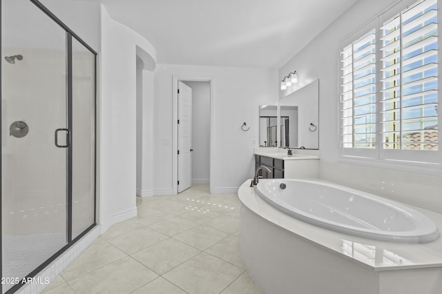 full bath with a wealth of natural light, tile patterned floors, a stall shower, and a garden tub