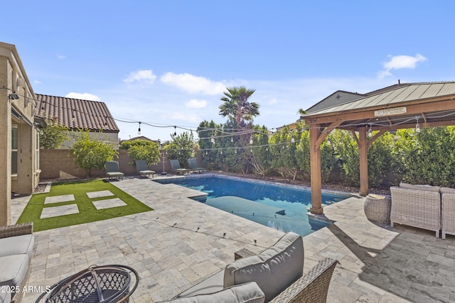 view of swimming pool with an outdoor living space, a fenced in pool, a fenced backyard, and a patio area