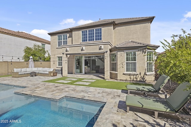 back of house featuring stucco siding, an outdoor living space, fence, a fenced in pool, and a patio area