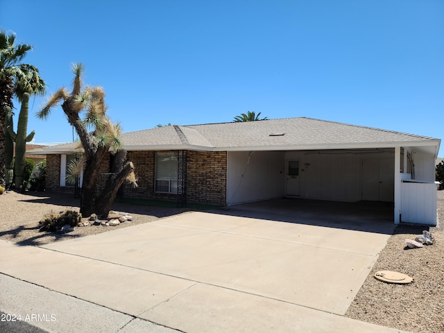 ranch-style home featuring a carport