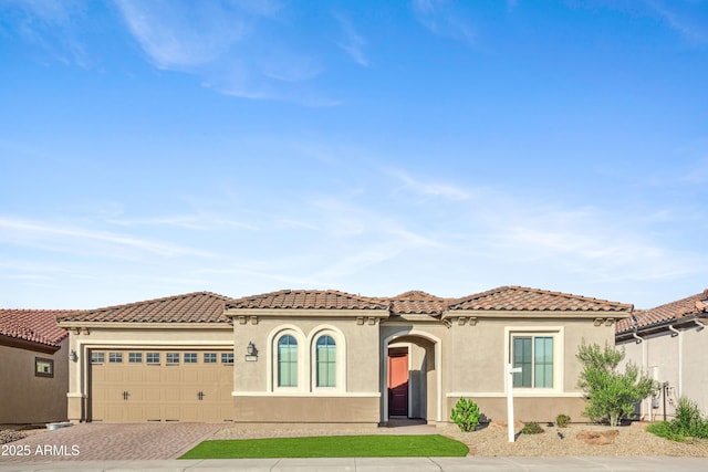 19045 N 269th Dr, Buckeye, AZ 85396 - mediterranean / spanish-style home featuring decorative driveway, a garage, stucco siding, and a tile roof