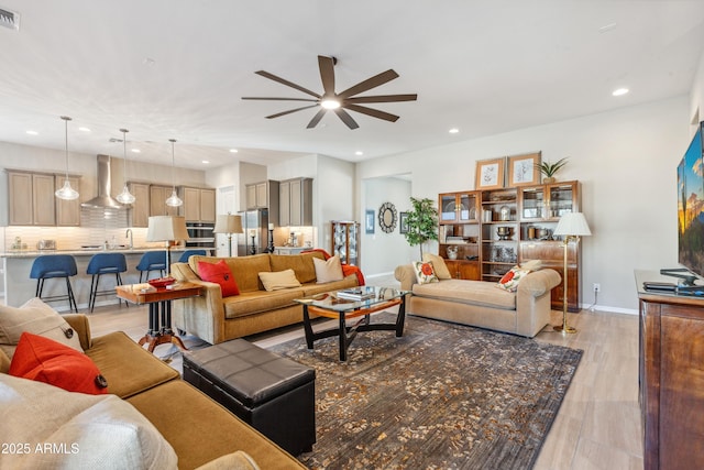 19045 N 269th Dr, Buckeye, AZ 85396 - living room with ceiling fan, recessed lighting, light wood-style flooring, and baseboards