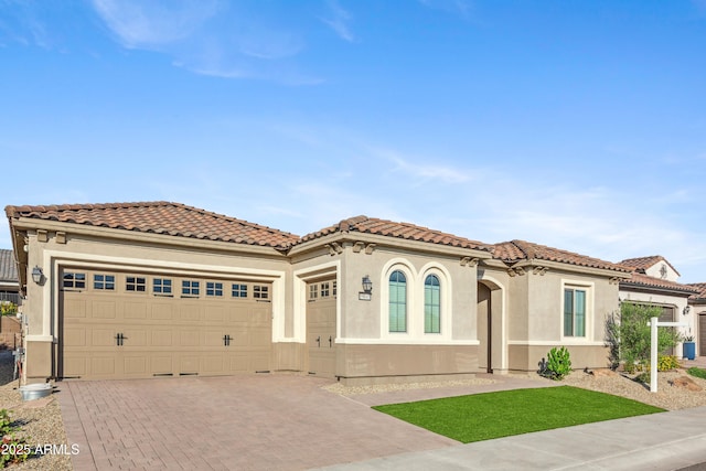 19045 N 269th Dr, Buckeye, AZ 85396 - mediterranean / spanish home with decorative driveway, an attached garage, stucco siding, and a tiled roof