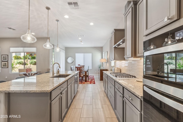19045 N 269th Dr, Buckeye, AZ 85396 - kitchen featuring a sink, gray cabinetry, appliances with stainless steel finishes, healthy amount of natural light, and recessed lighting