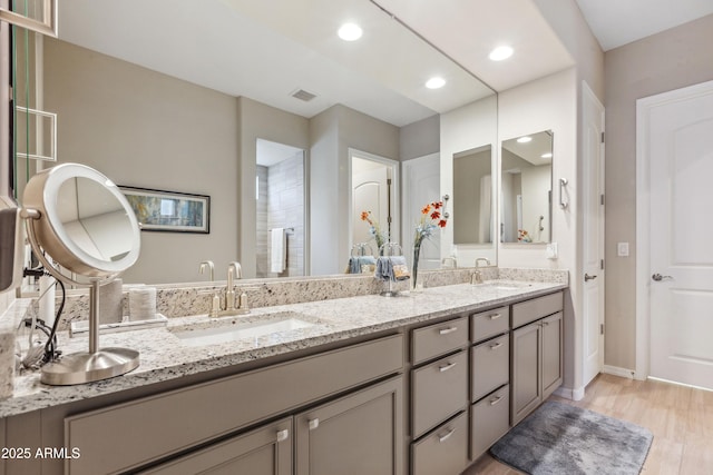 19045 N 269th Dr, Buckeye, AZ 85396 - full bath featuring double vanity, baseboards, recessed lighting, and wood finished floors