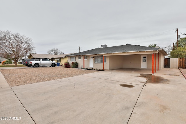 ranch-style house featuring a carport