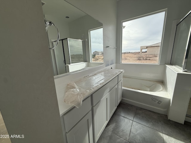 full bathroom with vanity, a shower, and a garden tub