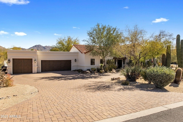 view of front of property featuring a garage and a mountain view