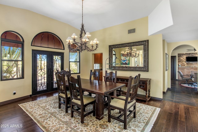 dining area with french doors, dark hardwood / wood-style floors, and a notable chandelier