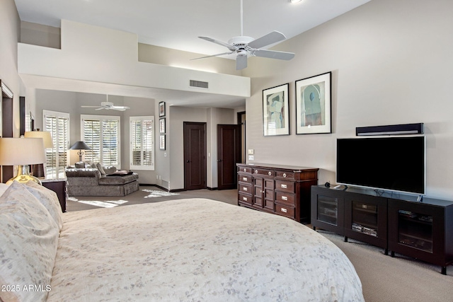 bedroom with a high ceiling, carpet, and ceiling fan