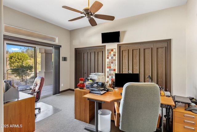 carpeted office featuring ceiling fan