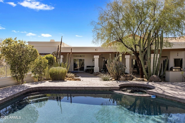 view of pool featuring a patio area and an in ground hot tub