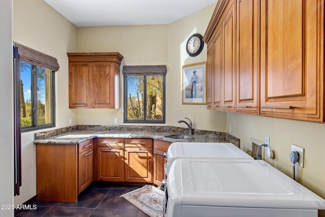 clothes washing area with sink, plenty of natural light, cabinets, and independent washer and dryer