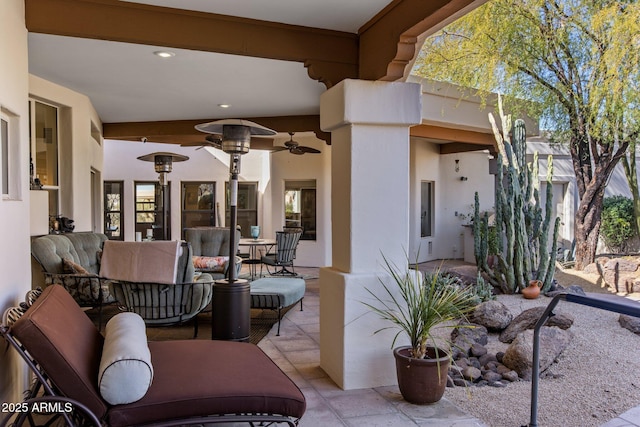 view of patio with an outdoor living space and ceiling fan