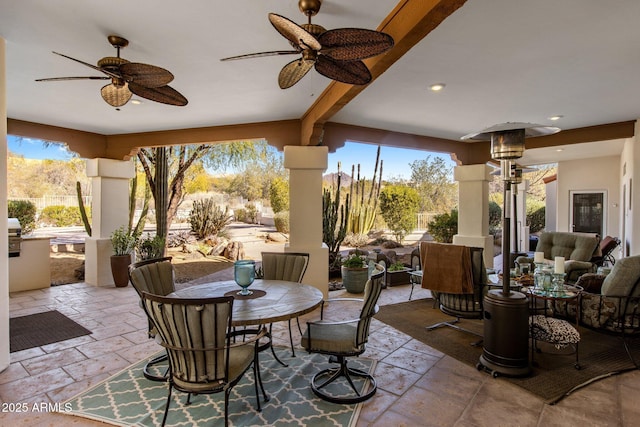 sunroom with a healthy amount of sunlight and ceiling fan