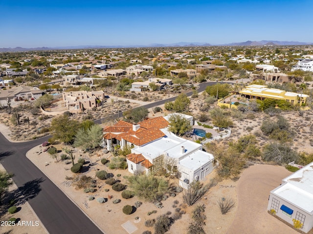 birds eye view of property with a mountain view