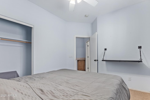 carpeted bedroom featuring a closet and ceiling fan