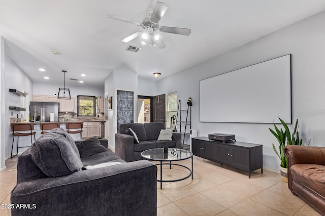 living room featuring light tile patterned floors and ceiling fan