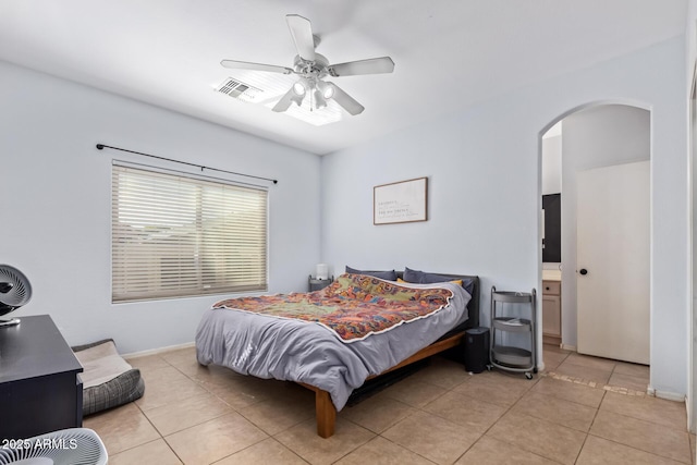 tiled bedroom featuring ceiling fan