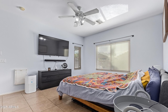 tiled bedroom featuring ceiling fan