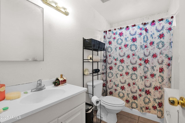 bathroom with toilet, vanity, tile patterned flooring, and walk in shower