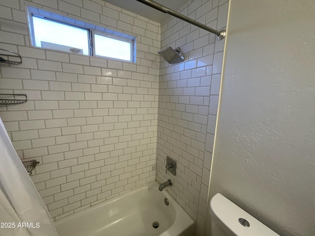 bathroom with toilet and shower / bath combo