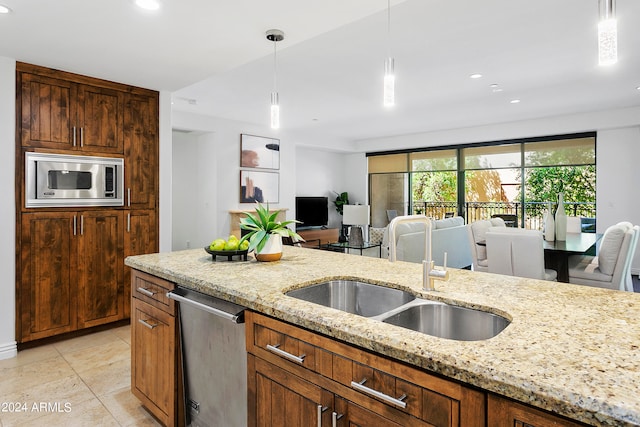 kitchen featuring pendant lighting, light tile patterned floors, sink, stainless steel appliances, and light stone countertops