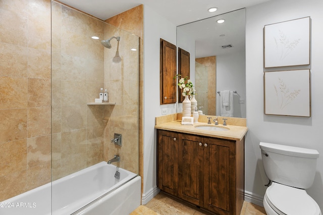 full bathroom featuring tiled shower / bath, vanity, tile patterned flooring, and toilet