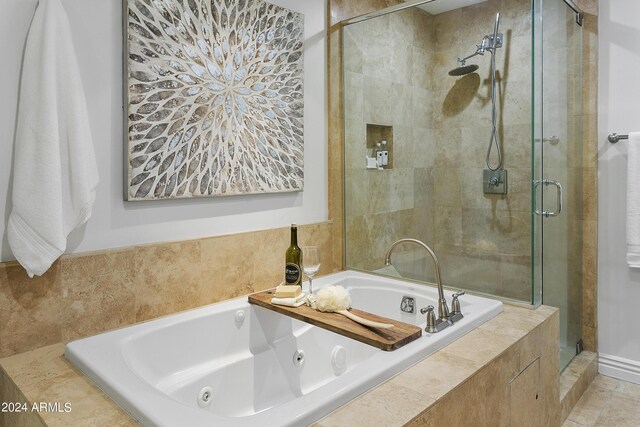 bathroom featuring shower with separate bathtub