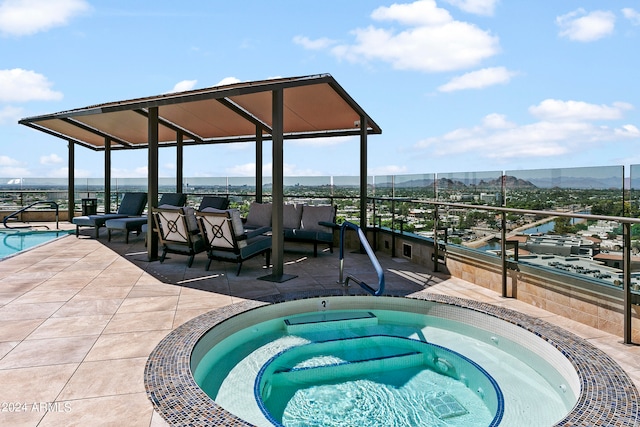 view of pool with a patio, a mountain view, and an in ground hot tub