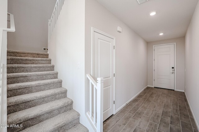 stairway with hardwood / wood-style floors