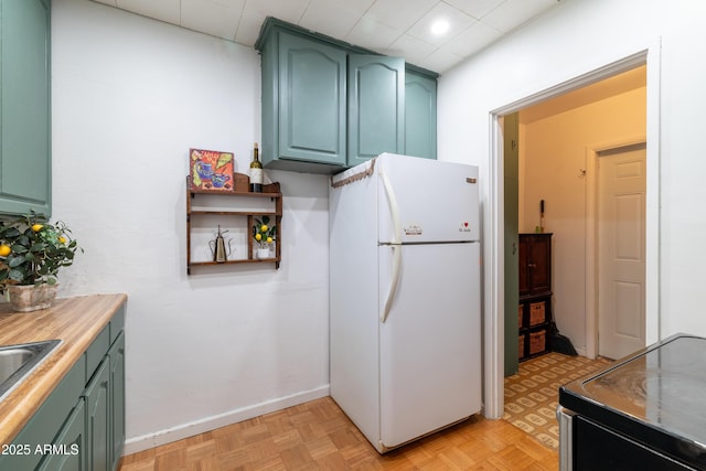 153 E Buena Vista Ave, Goodyear, AZ 85338 - kitchen featuring freestanding refrigerator, green cabinetry, light countertops, and electric range oven