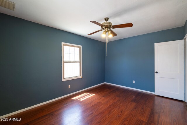 153 E Buena Vista Ave, Goodyear, AZ 85338 - empty room with dark wood-style flooring and a ceiling fan