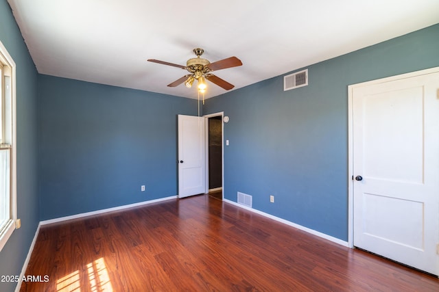 153 E Buena Vista Ave, Goodyear, AZ 85338 - unfurnished bedroom with wood finished floors and ceiling fan
