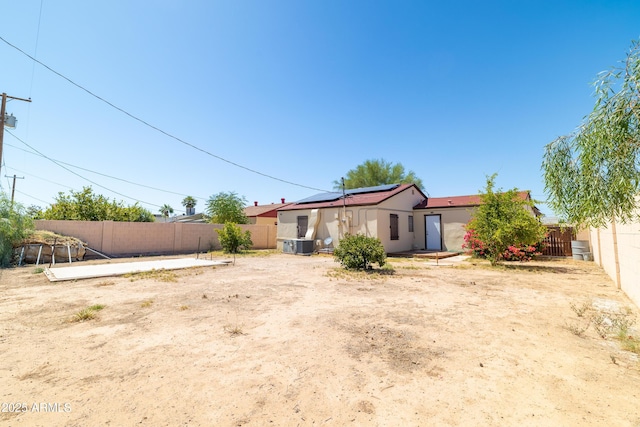 153 E Buena Vista Ave, Goodyear, AZ 85338 - rear view of house with roof mounted solar panels, a fenced backyard, and stucco siding