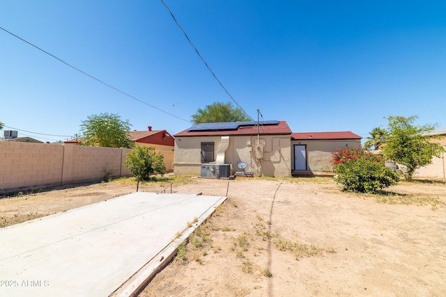 153 E Buena Vista Ave, Goodyear, AZ 85338 - rear view of property with stucco siding and roof mounted solar panels