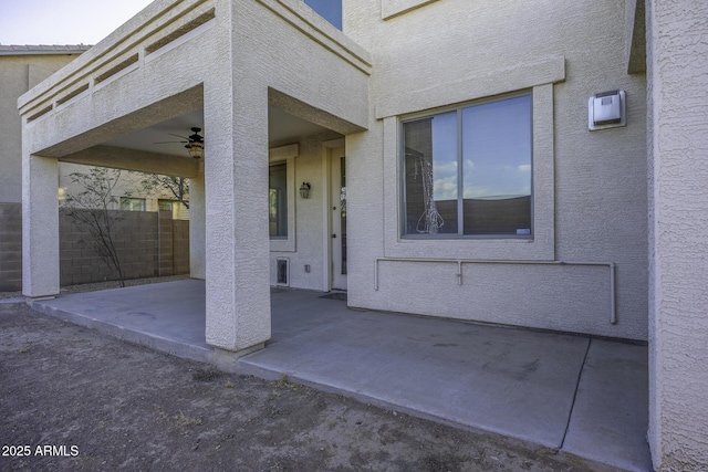 property entrance featuring a patio area and ceiling fan