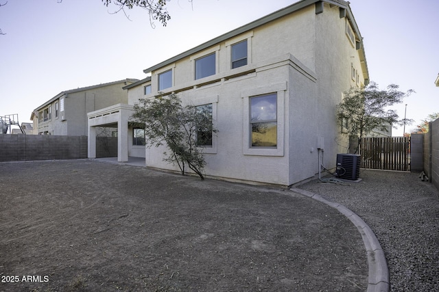 rear view of house with a patio and central air condition unit