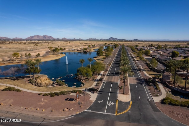 birds eye view of property with a water and mountain view