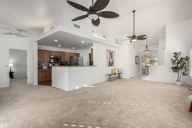 unfurnished living room featuring light carpet, high vaulted ceiling, and ceiling fan