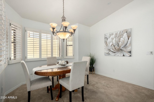 carpeted dining space with a notable chandelier and vaulted ceiling