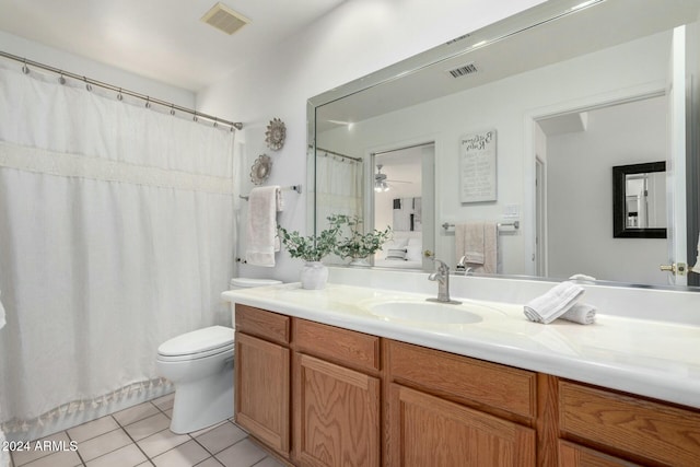 bathroom with tile patterned flooring, vanity, and toilet