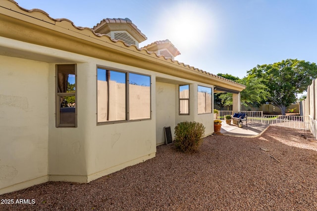 view of side of property featuring a patio area