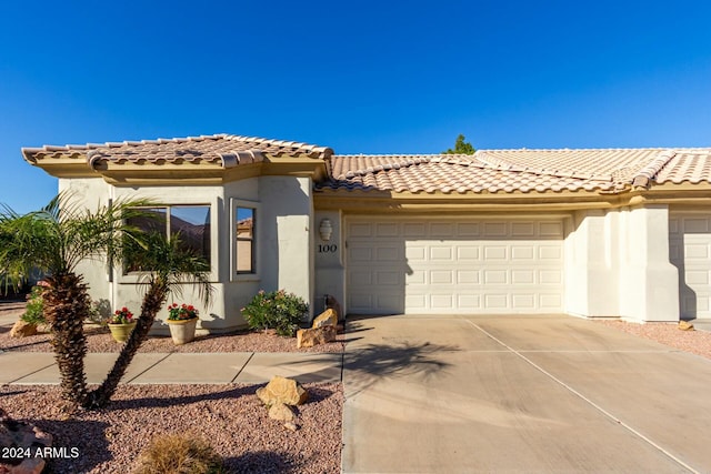 mediterranean / spanish-style home featuring a garage