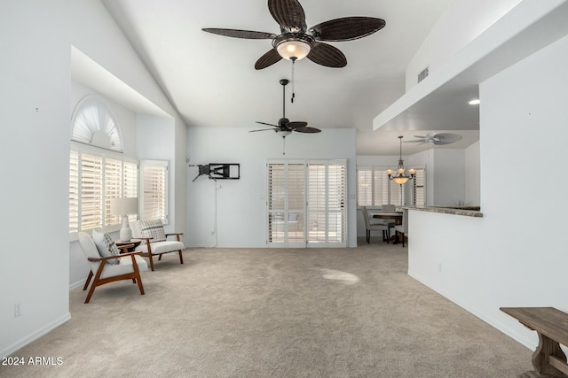 living area with ceiling fan with notable chandelier, lofted ceiling, and light colored carpet