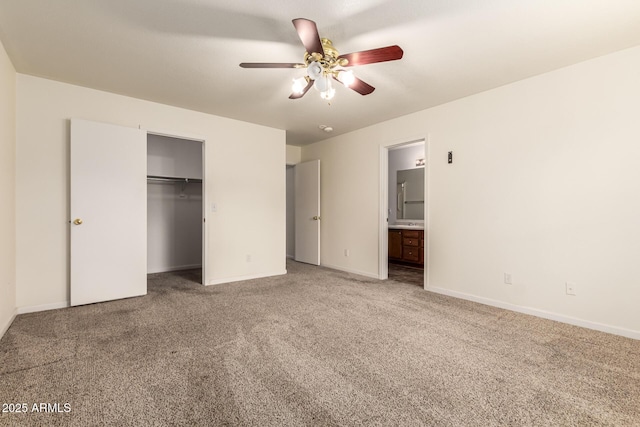 unfurnished bedroom with ceiling fan, a closet, ensuite bathroom, and carpet