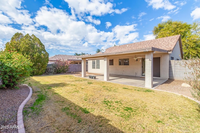 back of house featuring a patio and a lawn